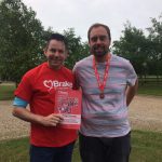 Tom and Phil show off their Zip Line Challenge certificate and medal